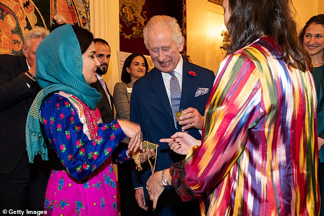 King Charles III speaks to representatives of Turquoise Mountain – founded to protect heritage and communities at risk – during a reception at Buckingham Palace to recognize Britain's contribution to humanitarian efforts around the world and to mark 60 years the Disasters Emergency Committee