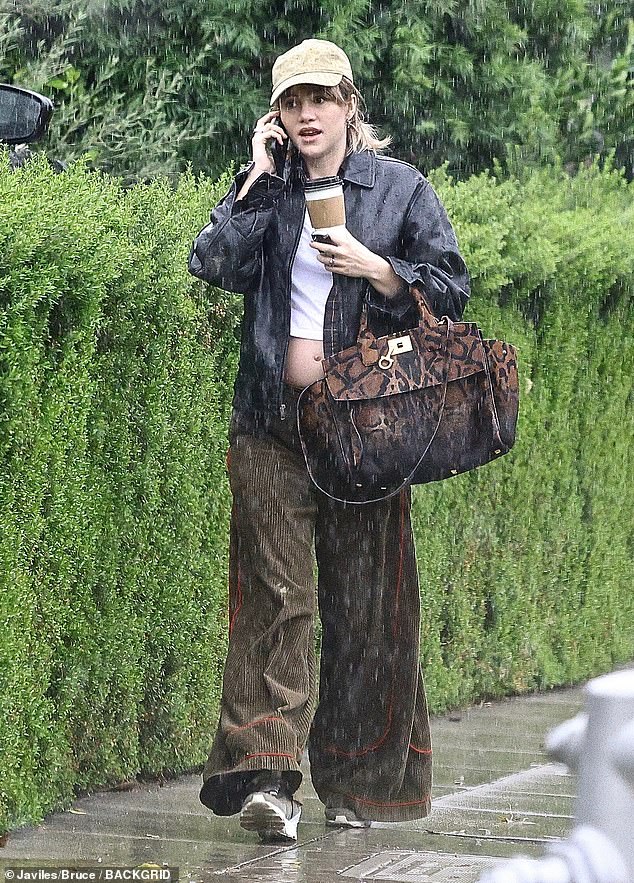 Pregnancy rumors: Suki Waterhouse bared her bump during a rainy outing in Beverly Hills on Wednesday, amid rumors she's expecting her first child with Robert Pattinson