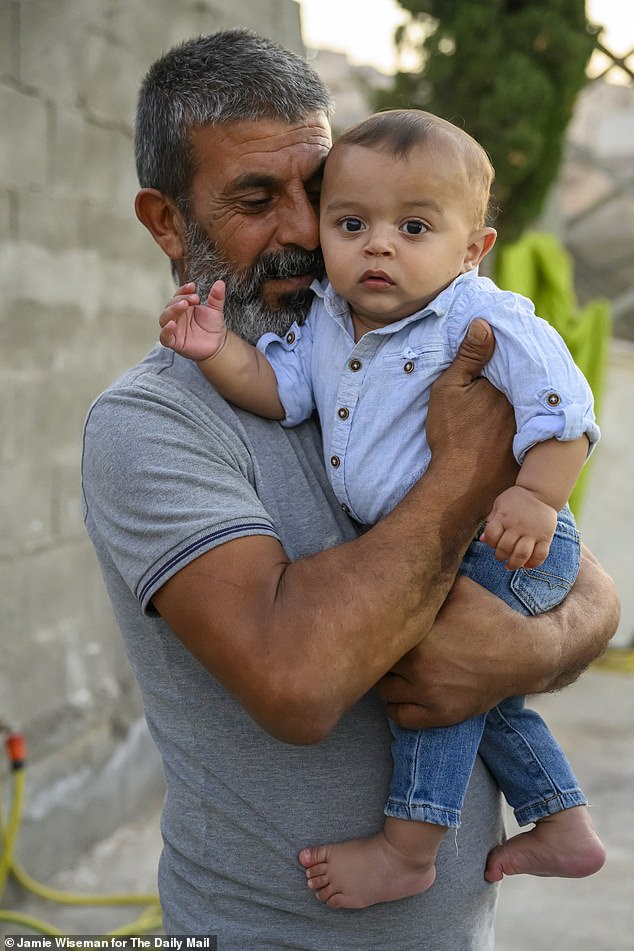 Hamid Abu Ar'ara (left), a Bedouin farmer, pictured with his eight-year-old son Elias