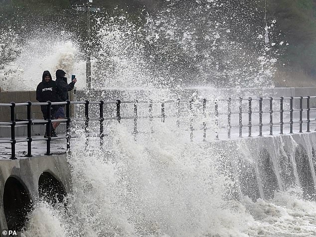 A new study claims that Britain will be bankrupt due to natural disasters in just 100 years.  Pictured: Waves crashing at Folkestone during Storm Ciaran in November