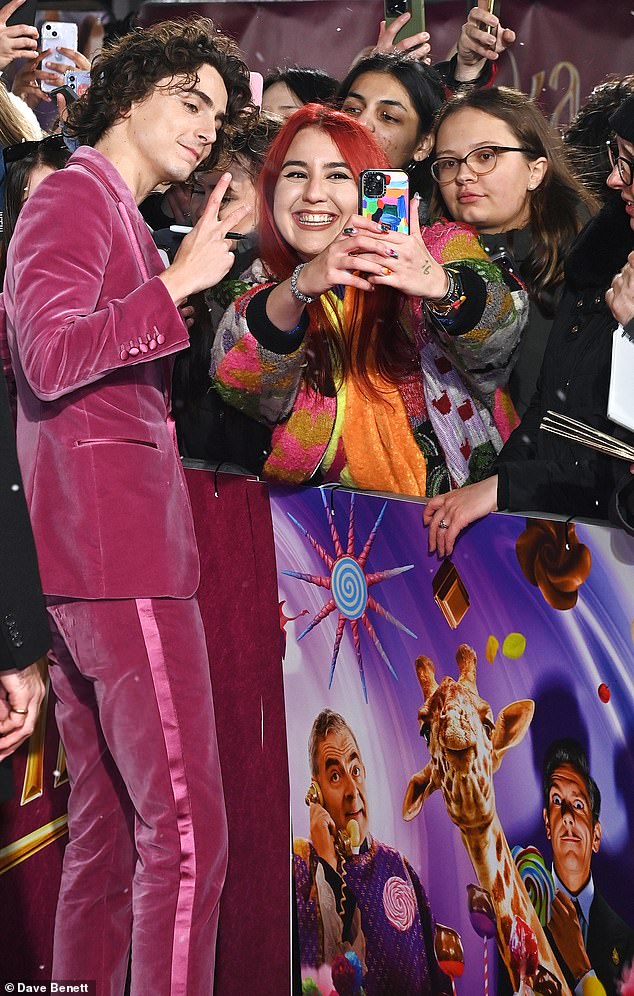 Sweet call!  Wonka star Timothee Chalamet poses with selfies at the London premiere of his new film on Tuesday evening;  the 27-year-old French-American star has seen hundreds of fans flock to catch a glimpse of him at the global premieres so far