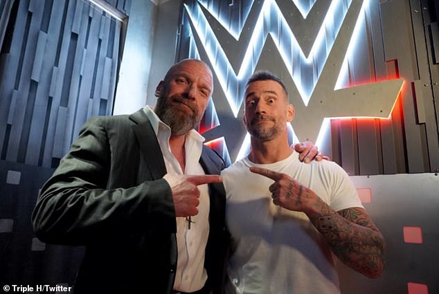 Punk posed backstage with WWE legend and CCO Triple H, in H's iconic pointing pose