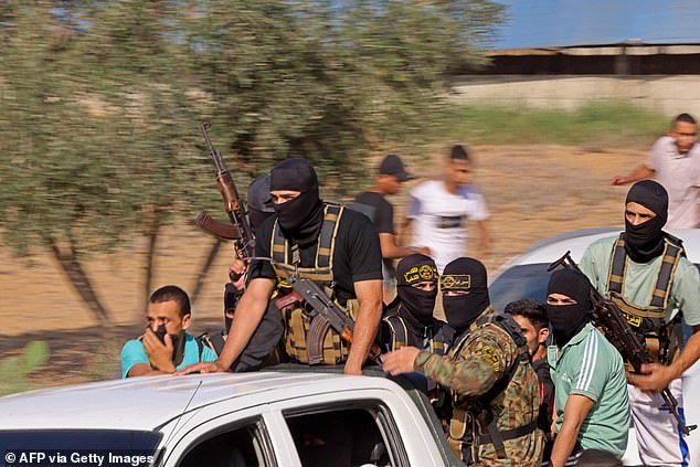 Hamas terrorists are seen driving towards the border fence with Israel in Gaza on October 7