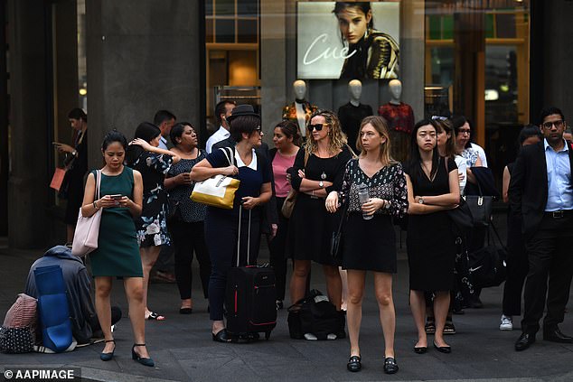 A growing number of bosses are demanding employees return to the office to boost workplace productivity (photo: office workers in Sydney's CBD)