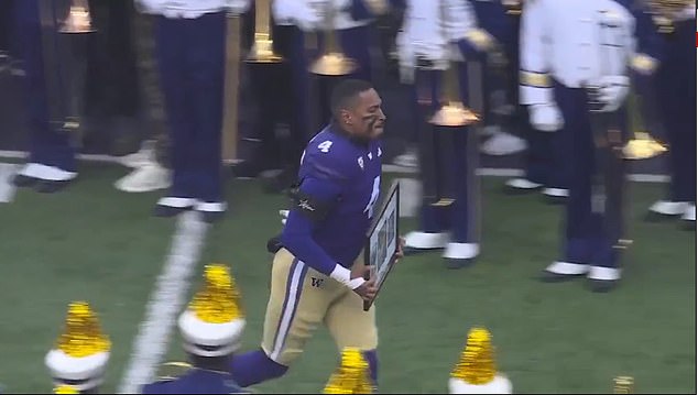 Tupuola-Fetui, whose father died last month, appeared to hold framed photos of his family as he took to the field