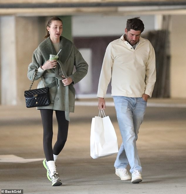 Casual cool: Meanwhile, Tim wore a white sweater over a gray T-shirt and light blue jeans.  He paired the outfit with white sneakers and was seen carrying a white bag