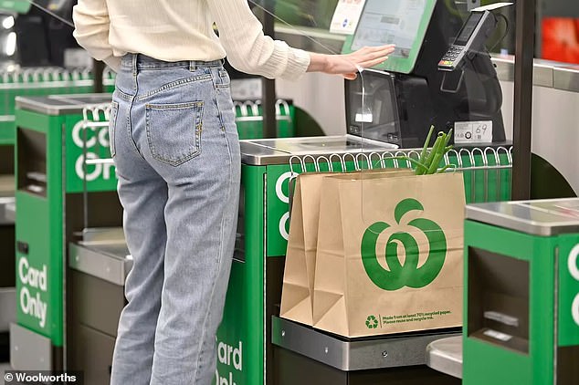 Woolworths CEO Brad Banducci has hit back at one of the biggest customer complaints in recent years - self-service checkouts.  A woman is pictured using a Woolworths self-service checkout