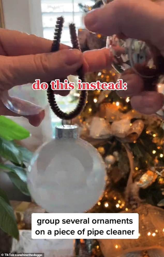 Instead of hanging the baubles individually, the ornament hack involves tying them in groups of four or five before attaching them to the Christmas tree.