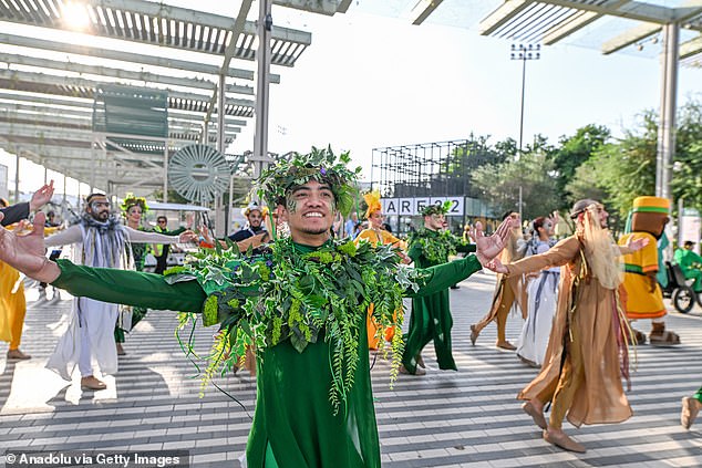 Performers greet those arriving for the Cop28 talks in the United Arab Emirates starting on Thursday