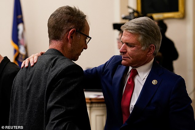 Congressman Michael McCaul introduced legislation, which passed the House of Representatives on Thursday, to freeze the funds.  He is pictured Wednesday with the father of a Hamas hostage speaking to relatives of those held by the terrorist group.