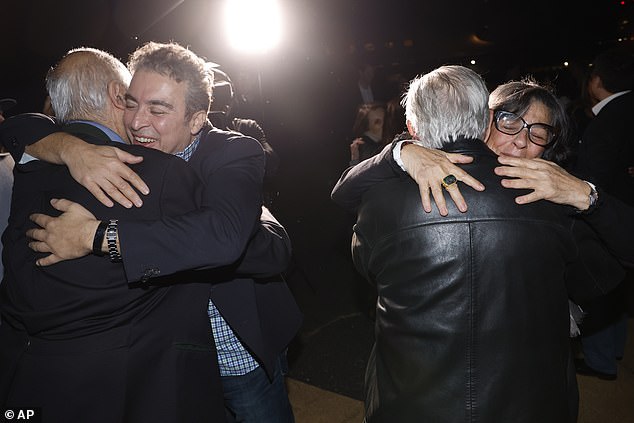 Family members hug freed Americans Siamak Namazi, Morad Tahbaz and Emad Shargi after they were released from Iran under the swap deal on September 19