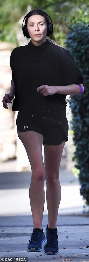 The Hollywood actress showed off her legs in gray running shorts, paired with a black Nike sports bra – which she put on display under a black sheer long-sleeved top