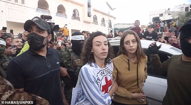 Mia Schem is released to the Red Cross as a crowd of Palestinians watch