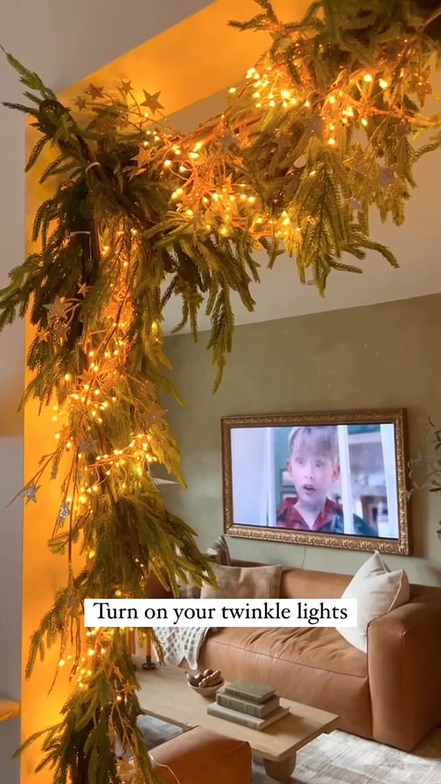 Wendy ended the video by showing off the finished product: a dazzling array of greenery mixed with gold lights hanging above her doorway