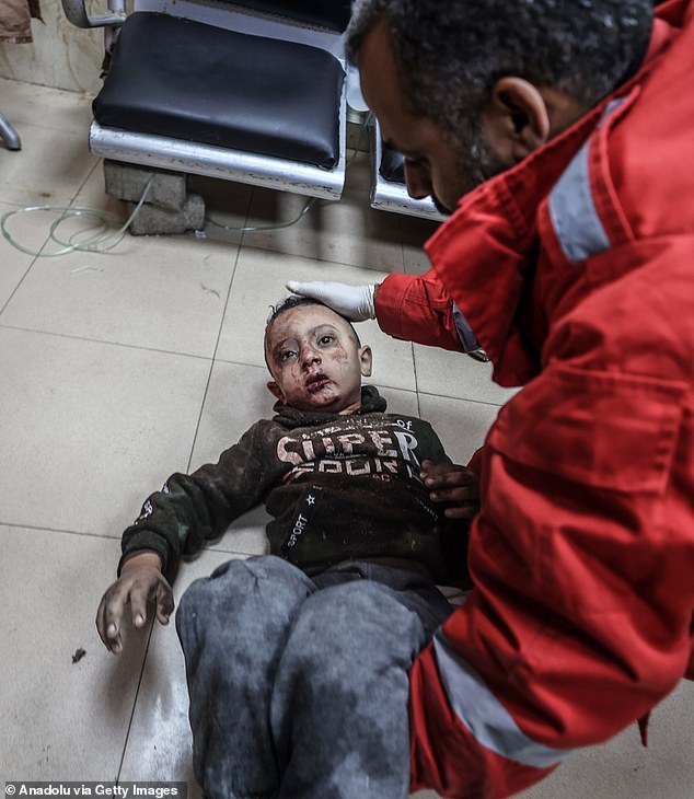 An injured Palestinian child is taken to Al-Aqsa Martyrs Hospital for treatment after Israeli attacks in Deir al-Balah, Gaza on December 1, 2023