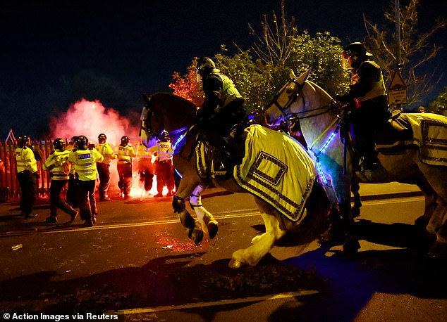 A police horse raises its front legs during the unrest outside Villa Park last night