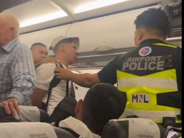 After demanding drinks from staff, the man then punched another passenger before being restrained with zip ties and escorted off the flight by Philippine police.