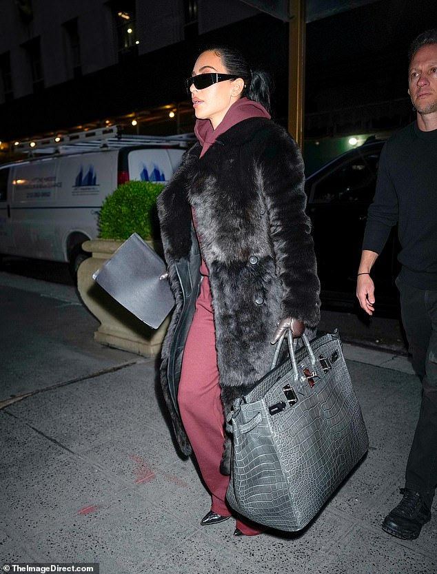 The reality TV star was as chic as ever as she made her way to a building in Manhattan.  Kanye West's ex wore an oversized black fur coat while carrying an extremely large $100,000 gray Hermes Birkin bag
