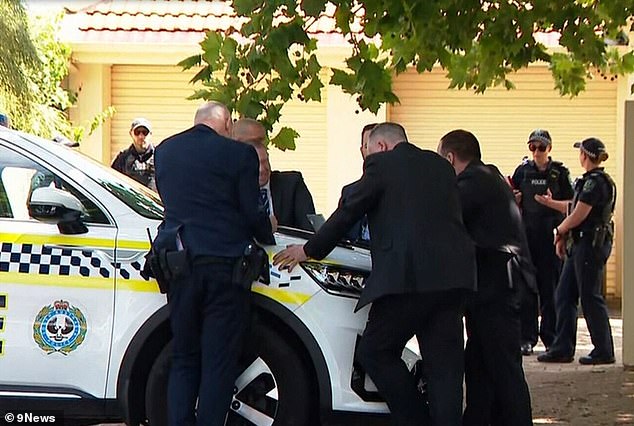 Detectives and forensic officers on Wednesday examined the home in Glenelg North where a father and son were found dead 15 hours apart in a suspected murder-suicide.