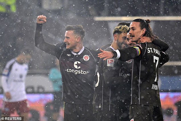 St.Pauli players celebrated after scandalous own goal gave them a two-goal cushion in the derby match