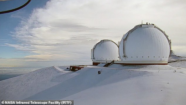 NASA's telescope is seen surrounded by snow on Friday morning, recording about two inches
