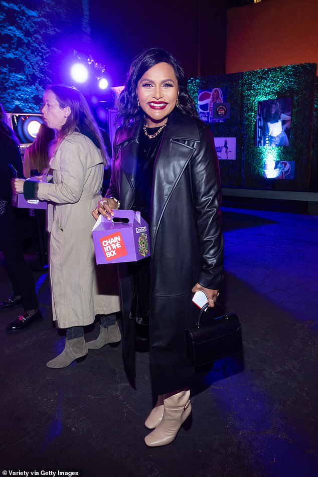 Mindy wore her raven braids slightly curled and accessorized with a gold chain