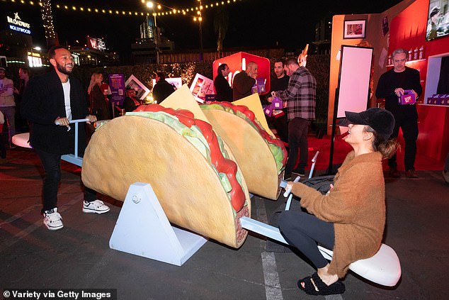 John and Chrissy - who have been married since 2013 - appeared to be having a blast as they hopped on a unique taco seesaw that was available for attendees to ride at the event