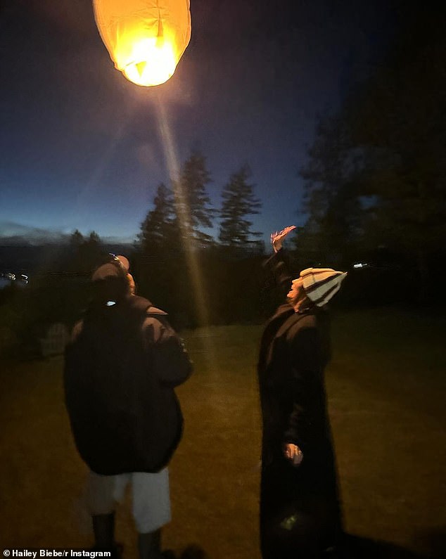 Hailey appeared in one photo outdoors looking at a paper lantern while wearing a black and white striped hat