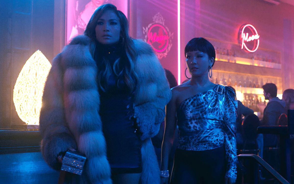 (L-R) Jennifer Lopez and Constance Wu standing in a nightclub in Hustlers.