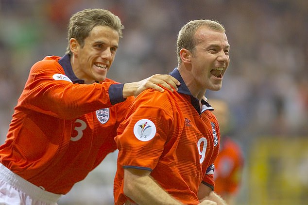 Phil Neville (left) gave away a penalty late in the match against Romania, leading to a 3–2 defeat and an early exit