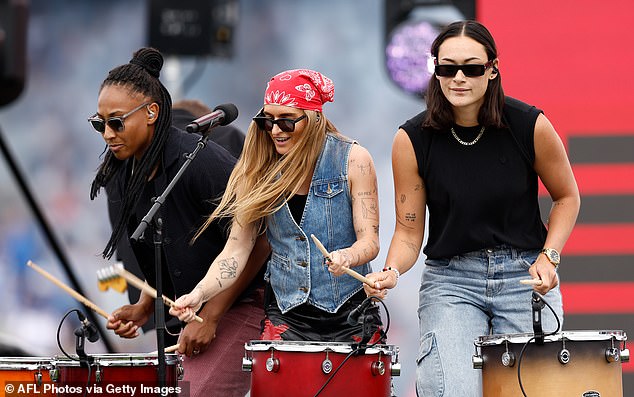 Their outfit was completed with a red bandana, a chunky silver chain and sunglasses