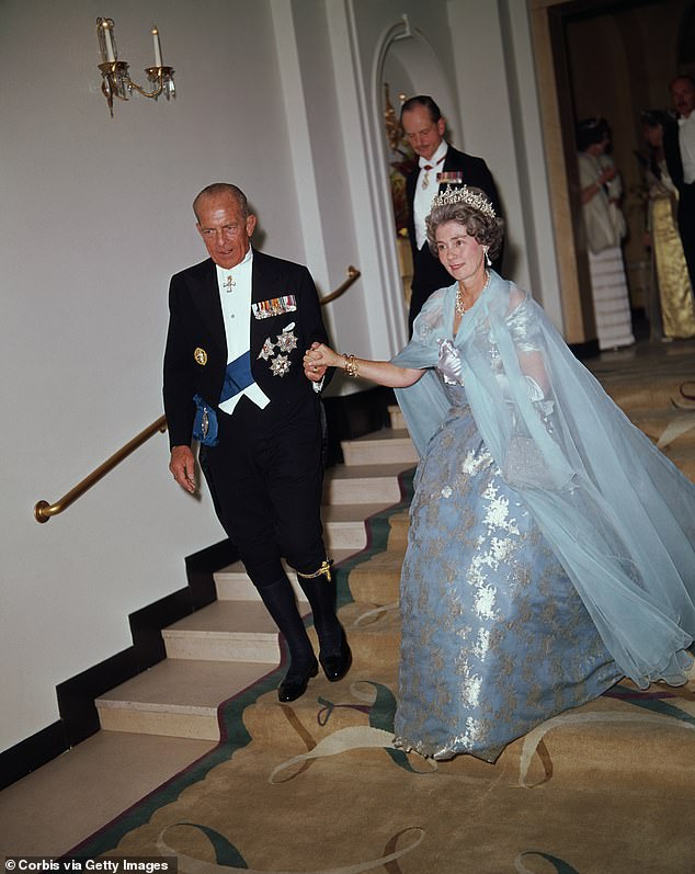 Paul I, King of the Hellenic Republic of Greece, accompanies his wife, Queen Frederica, as they descend a flight of stairs