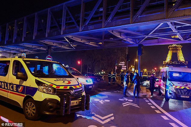 A man has been stabbed to death, while a British tourist is said to have been seriously injured along with two others after a knifeman shouting 'Allahu Akbar' launched a frenzied attack in Paris.  In the photo: Police secure the entrance to the Bir-Hakeim Bridge near the Eiffel Tower