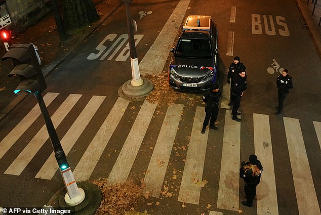 Police officers stand guard.  According to the police, there are no indications yet about the motive for the stabbing