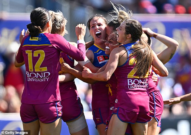 Lions players celebrate after Breanna Koenen scored a goal for her team in the match