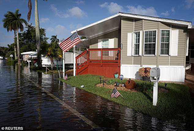 Rising premiums are driven by a number of factors, including more frequent devastating weather events and costly car accidents.  Pictured is a flooded house in Florida in November