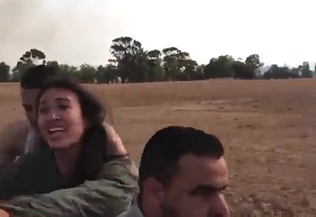 Student Noa Argamani sits on the back of a terrorist's motorcycle, her outstretched arms pointing to her helpless friend, pleading for her life