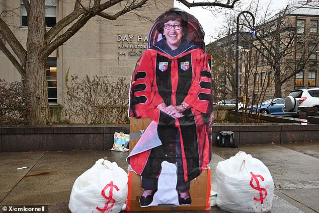 A cardboard cutout of the university president is seen next to 'money bags' during the mock trial, held by the raging anti-Israel students