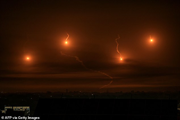Israeli flares illuminate the sky over Khan Yunis in the southern Gaza Strip, on December 3, 2023