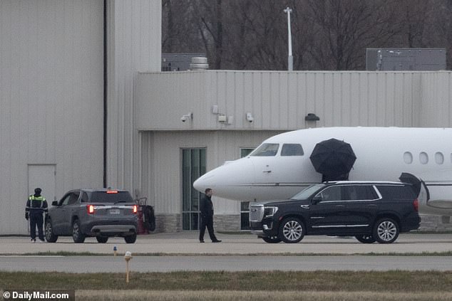 The pop star's caregivers set up umbrellas to block prying eyes as she headed to Green Bay