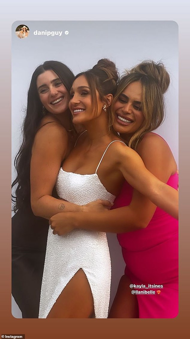 Another cheerful photo showed Kayla sandwiched between two friends, looking happy and beautiful in a white slit skirt with a matching white top