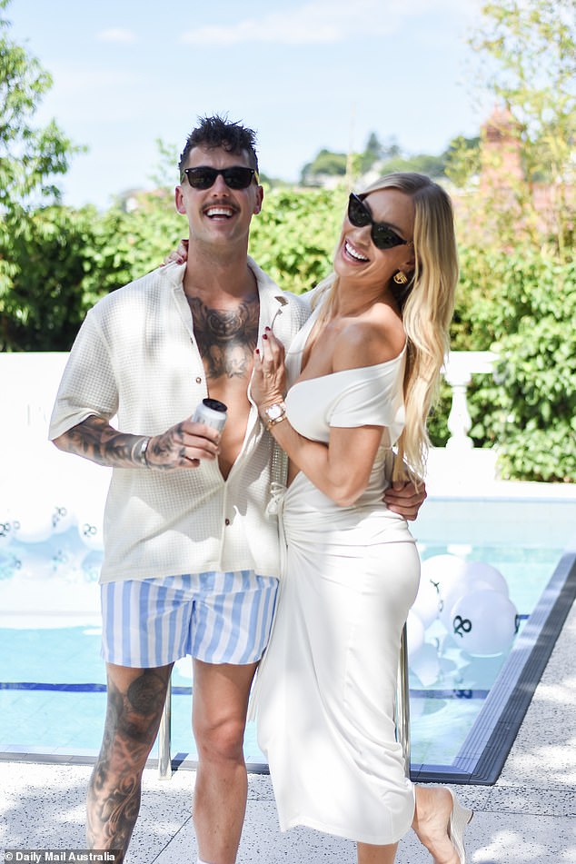 The glamorous blonde stunned in a white off-the-shoulder dress with a cut-out midriff.  Pictured with Alan Wallace