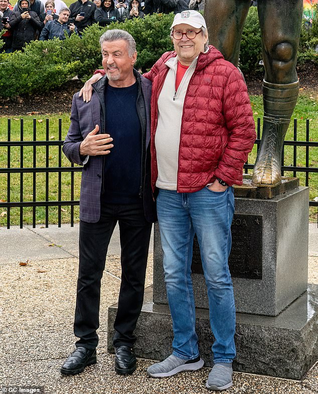 Chase, who spent five weeks in the hospital with a heart condition in 2021, eventually stood up for a photo with Stallone