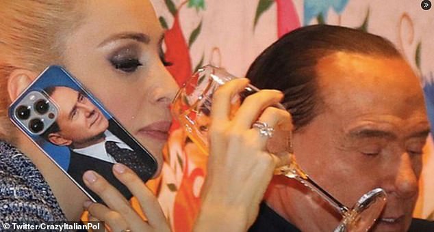 Marta Fascina wears a phone case featuring the younger Silvio Berlusconi, her husband