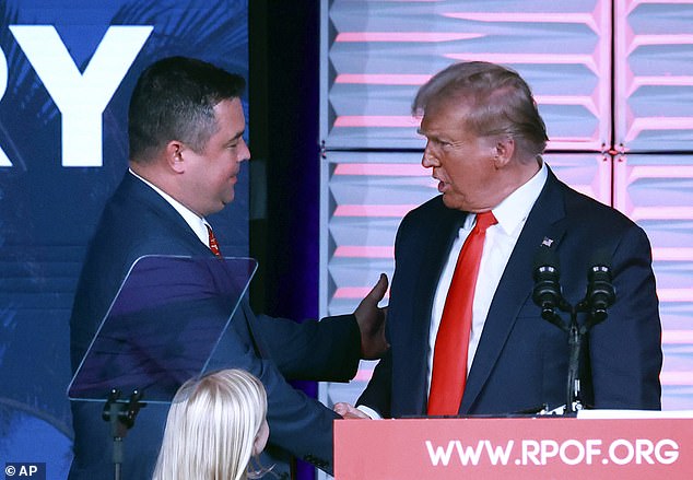 Ziegler, left, greets former President Donald Trump at the RPOF Freedom Summit on November 4, 2023 in Kissimmee, Florida