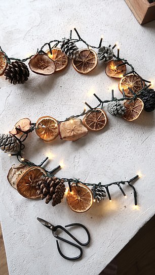 The mother combined dried fruit and painted pine cones to make garlands