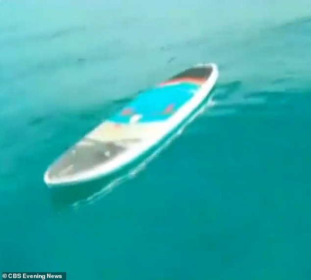 Woman's paddleboard is pictured floating in the water at Sandals resort, following Monday morning's fatal shark attack