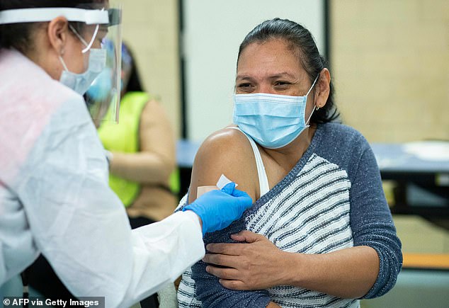 A woman receives a dose of the Moderna coronavirus (COVID-19) vaccine at a vaccination site in New York in 2021