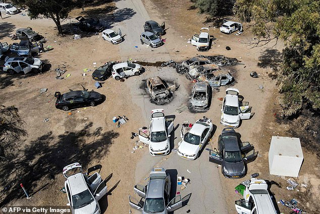 Abandoned and torched vehicles at the site of the October 7 attack on the Supernova Desert Music Festival in southern Israel