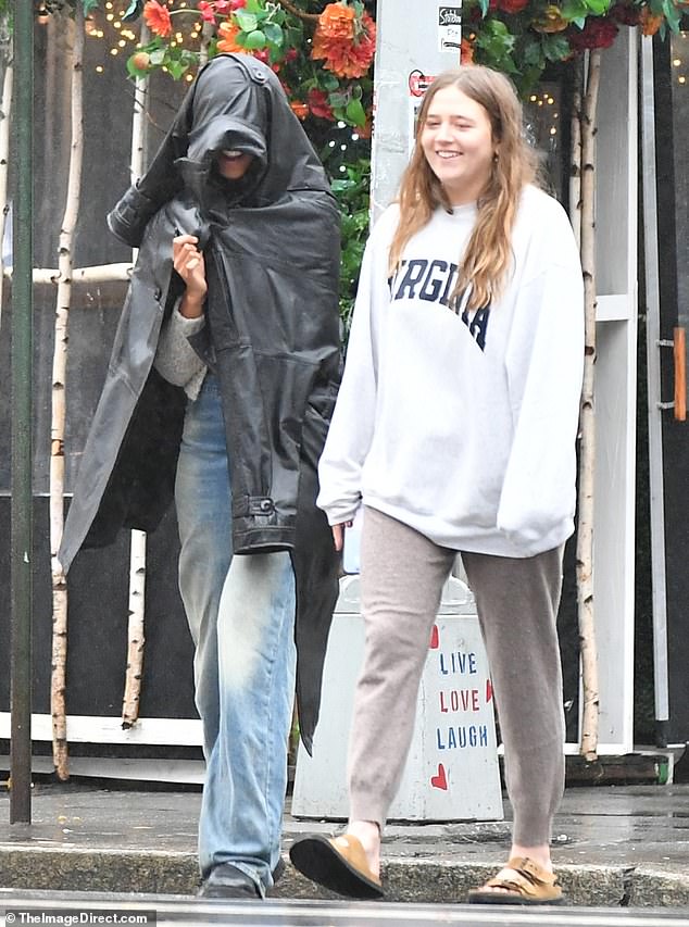 Malia was dressed in a gray sweater, faded baggy jeans and black lug sole boots, perfect for walking through puddles on a rainy day.